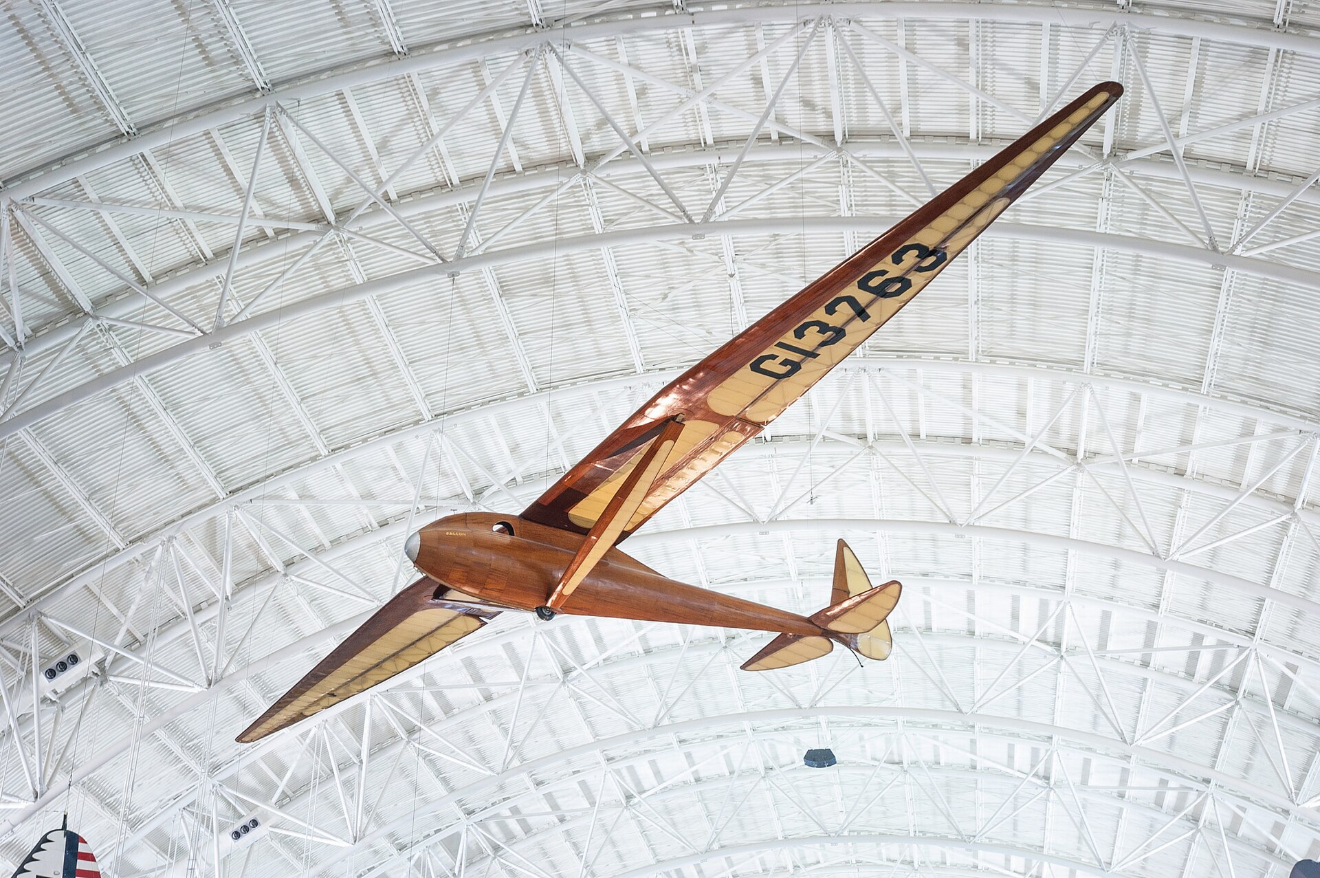 Monoplane glider with strut-braced, gull-type wing mounted high on monocoque fuselage; wooden construction with steel and aluminum fittings and controls; fuselage and wing leading edge covered with mahogany plywood. Fuselage skin applied over laminated Spruce bulkheads. Landing gear consists of single-wheel and .... [size?] tire mounted beneath forward fuselage, spring-steel tail skid beneath rudder. Cockpit covered with hood made from laminated Spruce bulkheads and covered with Mahogany plywood. Circular openings cut into hood on either side of pilot's head. Instrumentation: altimeter, airspeed, variometer plus a bank-and-turn indicator powered by low-speed venturi tube installed on retractable mount beneath right wingroot. Areas aft of wing spar and all control surfaces covered with glider cloth. Cloth is doped directly onto ribs and plywood skin without stitching for smooth finish. Constant-chord wing from fuselage to mid-span, tapered profile from mid-span to wingtip; constant-chord, split-trailing edge flaps and high-aspect ratio ailerons. A Gö 549 airfoil is used at the wing root, becoming symmetrical at the tip. All-flying elevator mounted on duraluminum torque-tube, rudder hinged to box-beam post, both surfaces built up from Spruce and covered with glider cloth. In 1933, Richard C. du Pont teamed with Hawley Bowlus and the two men set up shop in San Fernando, California, to build gliders. Their most successful competition sailplane was the Senior Albatross. The Bowlus shop built four and Warren Eaton bought the third in May 1934. He named the sailplane "Falcon" and flew it often including over the Blue Ridge Mountains from an airfield at Big Meadows, VA, in 1934. Eaton had served in the U. S. Army Air Service during World War I and flown SPAD XIII fighters (see NASM collection) in the 103rd Aero Squadron, 3rd Pursuit Group, at Issoudon, France, from August 27, 1918, until Armistice Day, November 11. Eaton led the effort to found the Soaring Society of America in 1932 and became the organization's first president. Long before he designed and built the Bowlus-du Pont "Falcon," William Hawley Bowlus had contributed to aviation history. In 1926, T. Claude Ryan hired him as factory manager at the Ryan Airlines, Inc., at San Diego, California. Late in February 1927, Bowlus and twenty Ryan workmen, supervised by chief engineer Donald A. Hall and Charles A. Lindbergh, built a long-range monoplane based on the Ryan M-2. Lindbergh christened the modified M-2 the "Spirit of St. Louis." It is said that Bowlus suggested several design features that Lindbergh approved and incorporated in the finished airplane. Bowlus renewed his friendship with Lindbergh late in 1929. He taught the ocean flyer and his wife, Anne Morrow Lindbergh, to fly sailplanes and in January 1930, both Charles and Anne completed their first solo glider flights. Hawley Bowlus developed the Senior Albatross series from a design that he called the Bowlus Super Sailplane. In Germany, designers and pilots led the world in building and flying high-performance gliders and Bowlus was strongly influenced by their work. He and German glider pioneer Martin Schempp taught courses in aircraft design and construction at the Curtiss-Wright Technical Institute in Glendale, California. The two instructors led a group of students who built the Super Sailplane in 1932. The wing of the Super was nearly a copy of the wing used on the German "Wein" sailplane designed and flown with great success in 1930 and 1931 by Robert Kronfeld. Both the Super Sailplane and the Senior Albatross employed the same Goettingen 549 wing airfoil and even the tips of the control surfaces curved to almost identical contours. When Bowlus built the Senior Albatross series, the cockpit enclosure closely resembled another record-setting and influential German sailplane called the "Fafnir" and designed by Alexander Lippisch specifically for pilot Gunther Groenhoff. Richard C. du Pont was also an important character in the history of the Senior Albatross. By the time he finished high school, this heir to the Delaware-based chemical empire could fly gliders with some skill. During his first year at the University of Virginia, he founded a campus soaring club. His passion for motor-less flight drew him farther away from traditional academics and in 1932, he transferred to the Curtiss-Wright Technical Institute. Mr. du Pont was probably among the students who built the Super Albatross. In 1933, du Pont teamed with Hawley Bowlus and the two men set up shop in San Fernando, California, to build gliders. Bowlus furnished the design expertise and performed much of the construction while du Pont supplied enthusiasm, financing, and additional labor. The Bowlus-DuPont Sailplane Company became an official entity in 1934, not in California but in Delaware. The firm folded in September 1936 but during its short life, the small factory built four examples of the Senior Albatross. No two were constructed exactly alike and a short history of each follows: -Prototype Sr Albatross called the Super Sailplane, 60-ft span straight wing, built 1932, landed in the ocean and destroyed fall 1932. -First two production Sr. Albatrosses, 62-ft span gull wing, a single-seat named Albatross I, and a two-seater named Dragonfly with pod fuselage and a metal boom aft fuselage, both with gull wings but no flaps, purchased by Richard du Pont in 1933. Dragonfly crashed at Elmira 1933 and later burned by du Pont. Du Pont sold Albatross I to Chet Decker. -Third production Sr. Albatross built to order for Warren Eaton, named Falcon and fitted with flaps, Eaton accepted the sailplane May 1934, flown at Elmira in national meet that year, Eaton died end of 1934, Eaton’s widow Genevieve donated to Smithsonian Institution in 1935. -Fourth production Sr. Albatross, Bowlus built a sister ship to Eaton’s Falcon called Albatross II and fitted with flaps like Falcon, sold to du Pont who flew it in 1934 national contest at Elmira. Flown many times but not owned by Lew Barringer, damaged by wind in 1935 and wreck sold to Jack O’Meara in 1935. All four sailplanes did have 'gull' wings (each wing was bent down slightly at about mid-span) and this feature differentiates these airplanes from the prototype Super Sailplane. Bowlus fitted two with wing flaps, Falcon and Albatross II, rather than spoilers, for better speed and altitude control during landing. Mahogany plywood skinned the Falcon and spruce plywood covered the other three aircraft, Dragonfly, Albatross I, and Albatross II. Bowlus sold each of these handcrafted airplanes for $2,500. Performance calculations revealed a best glide ratio of 23:1 when flying at 64.4 km/h (40 mph). If it became necessary, the pilot of a Senior Albatross could push his mount well over 161 km/h (100 mph) as long as he never exceeded a speed of 241.5 km/h (150 mph). With an accomplished pilot at the controls, the Senior Albatross could fly better than any other American sailplane and they were very pleasing to look at, too. A quotation from the July 1934 issue of "Aviation," a popular aviation periodical of the day, sums up one writer's impressions of the Senior Albatross: "Few flying machines have ever exhibited such an extraordinary combination of workmanship, finish, and aerodynamic refinement, so that it seems quite safe to say that the new ships represent the ultimate in soaring design practice in the United States, if not the world." The pilots who flew the Senior Albatross nearly dominated American competitive soaring. In September 1933, Richard du Pont flew the first Senior Albatross, Albatross I, at the fourth U. S. National Soaring Championships held at Elmira, New York. On September 21, du Pont set the American sailplane distance record by flying 196 km (121.6 miles). On June 25, 1934, he flew to within 3.2 km (2 miles) of New York City and established a new world distance record of 254 km (158 miles). On June 30, 1934, du Pont set the U. S. altitude record for sailplanes by climbing to 1,892 m (6,223 ft). The following year, Lewin Barringer soared du Pont’s Albatross II parallel to the ridges of the Allegheny Mountains for 250.3 km (155.5 miles). Du Pont sold Albatross I to Chet Decker who competed with the sailplane in the 1936 U. S. National contest held at Elmira, NY. In May 1934, Warren E. Eaton acquired from Hawley Bowlus the Senior Albatross Falcon that is now preserved at NASM. Eaton was already a veteran aviator. He had joined the U. S. Army Air Service and flown SPAD XIII fighters (see NASM collection) in the 103rd Aero Squadron, 3rd Pursuit Group, at Issoudon, France, from August 27, 1918, until Armistice Day, November 11. He was credited with downing one enemy aircraft in aerial combat. After the war, Eaton founded the Soaring Society of America and became the organization's first president. Eaton had commissioned Bowlus to build a Senior Albatross after he saw Richard du Pont fly the Albatross I at the U. S. Nationals the year before. Eaton asked Bowlus to fit flaps to his aircraft and to skin it with mahogany plywood. He christened it Falcon and it bore the federal aircraft registration number G13763. Several gold decals edged in black also appeared at various locations on the fuselage. "Warren E. Eaton" and "Falcon" appeared on both sides of the nose. A stylized albatross and the company motto "On the Wings of an Albatross" were applied to the vertical fin above the words "Bowlus-du Pont Sailplane Company." Eaton first flew the glider at San Diego. In June, he brought it to the national contest atop Harris Hill outside Elmira, New York. At Big Meadows, Virginia, Eaton set the American soaring altitude record, 2,765 m (9,094 ft), during September 1934. Three months later, Eaton died in Florida flying a Franklin primay glider. In 1935, Warren Eaton's widow, Genevieve, donated the Falcon to the Smithsonian Institution. It arrived in Washington on May 28 and a few days later, museum personnel suspended the glider from the ceiling of the West Hall of the Arts and Industries Building where it remained on display for many years. Wingspan: 18.8 m (61 ft 9 in) Length: 7.2 m (23 ft 7 in) Height: 1.6 m (5 ft 4 in) Weight: Empty, 153 kg (340 lb) Gross, 236 kg (520 lb) References and Further Reading: Blacksten, Raul. "On the Wings of an (Senior) Albatross." Unpublished manuscript, May 2000. Crouch, Tom D., ed. "Charles A. Lindbergh - An American Life." Washington: Smithsonian Institution Press, 1977. Frebert, George, and Haskell, Debbie, ed. "Deleware Aviation History." Dover: Litho Printing Co., 1998. Ross, Harland. "A Bowlus Outline," "Bungee Cord," Vol. 6 No. 4, Winter 1980. Simons, Martin. "The World's Vintage Sailplanes 1908-1945." Melbourne, Australia: Kookaburra, 1986. Senior Albatross curatorial file, Aeronautics Division, National Air and Space Museum. Russell Lee, 7/23/12, rev. 11/5/20