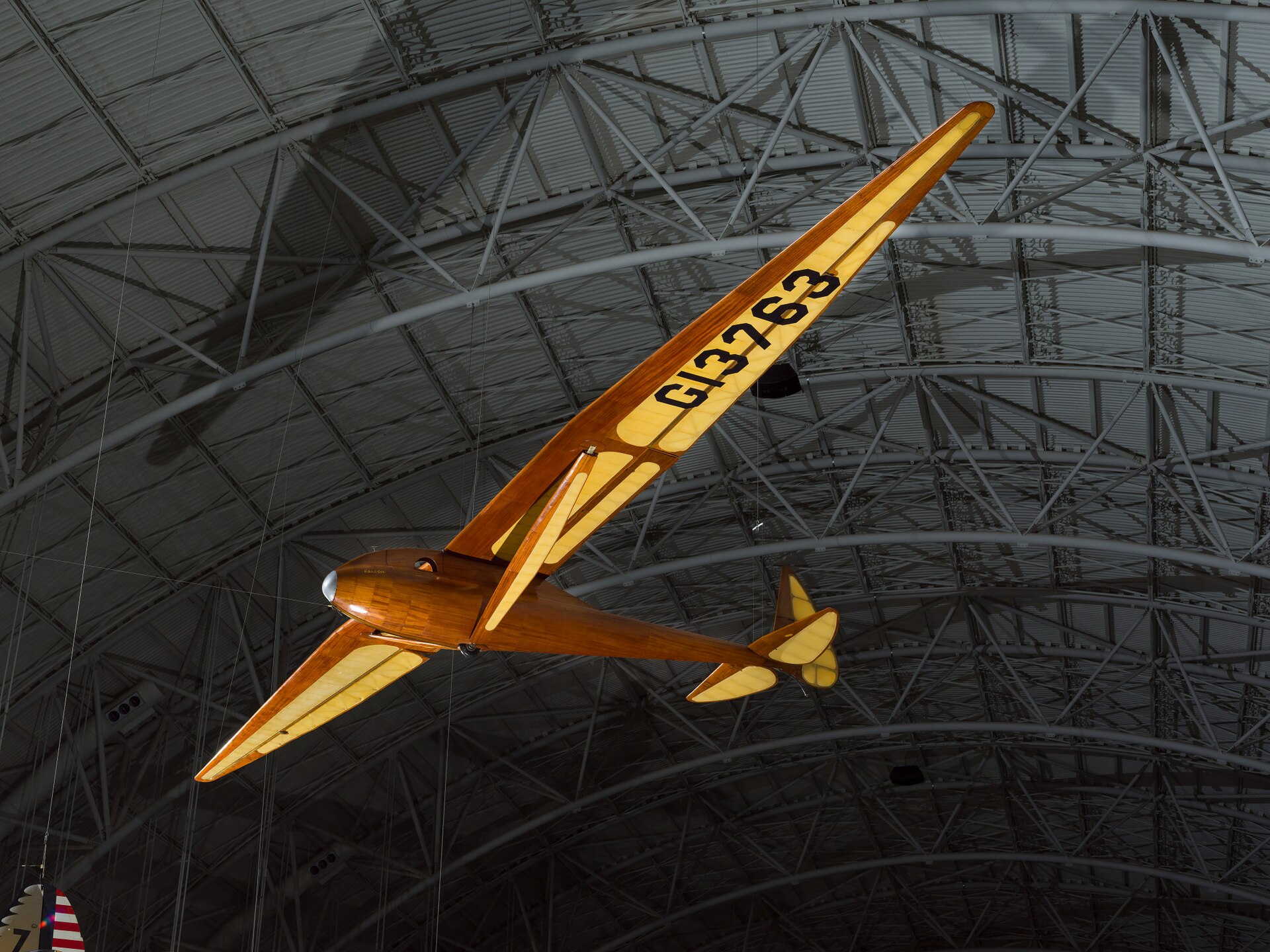 Monoplane glider with strut-braced, gull-type wing mounted high on monocoque fuselage; wooden construction with steel and aluminum fittings and controls; fuselage and wing leading edge covered with mahogany plywood. Fuselage skin applied over laminated Spruce bulkheads. Landing gear consists of single-wheel and .... [size?] tire mounted beneath forward fuselage, spring-steel tail skid beneath rudder. Cockpit covered with hood made from laminated Spruce bulkheads and covered with Mahogany plywood. Circular openings cut into hood on either side of pilot's head. Instrumentation: altimeter, airspeed, variometer plus a bank-and-turn indicator powered by low-speed venturi tube installed on retractable mount beneath right wingroot. Areas aft of wing spar and all control surfaces covered with glider cloth. Cloth is doped directly onto ribs and plywood skin without stitching for smooth finish. Constant-chord wing from fuselage to mid-span, tapered profile from mid-span to wingtip; constant-chord, split-trailing edge flaps and high-aspect ratio ailerons. A Gö 549 airfoil is used at the wing root, becoming symmetrical at the tip. All-flying elevator mounted on duraluminum torque-tube, rudder hinged to box-beam post, both surfaces built up from Spruce and covered with glider cloth. In 1933, Richard C. du Pont teamed with Hawley Bowlus and the two men set up shop in San Fernando, California, to build gliders. Their most successful competition sailplane was the Senior Albatross. The Bowlus shop built four and Warren Eaton bought the third in May 1934. He named the sailplane "Falcon" and flew it often including over the Blue Ridge Mountains from an airfield at Big Meadows, VA, in 1934. Eaton had served in the U. S. Army Air Service during World War I and flown SPAD XIII fighters (see NASM collection) in the 103rd Aero Squadron, 3rd Pursuit Group, at Issoudon, France, from August 27, 1918, until Armistice Day, November 11. Eaton led the effort to found the Soaring Society of America in 1932 and became the organization's first president. Long before he designed and built the Bowlus-du Pont "Falcon," William Hawley Bowlus had contributed to aviation history. In 1926, T. Claude Ryan hired him as factory manager at the Ryan Airlines, Inc., at San Diego, California. Late in February 1927, Bowlus and twenty Ryan workmen, supervised by chief engineer Donald A. Hall and Charles A. Lindbergh, built a long-range monoplane based on the Ryan M-2. Lindbergh christened the modified M-2 the "Spirit of St. Louis." It is said that Bowlus suggested several design features that Lindbergh approved and incorporated in the finished airplane. Bowlus renewed his friendship with Lindbergh late in 1929. He taught the ocean flyer and his wife, Anne Morrow Lindbergh, to fly sailplanes and in January 1930, both Charles and Anne completed their first solo glider flights. Hawley Bowlus developed the Senior Albatross series from a design that he called the Bowlus Super Sailplane. In Germany, designers and pilots led the world in building and flying high-performance gliders and Bowlus was strongly influenced by their work. He and German glider pioneer Martin Schempp taught courses in aircraft design and construction at the Curtiss-Wright Technical Institute in Glendale, California. The two instructors led a group of students who built the Super Sailplane in 1932. The wing of the Super was nearly a copy of the wing used on the German "Wein" sailplane designed and flown with great success in 1930 and 1931 by Robert Kronfeld. Both the Super Sailplane and the Senior Albatross employed the same Goettingen 549 wing airfoil and even the tips of the control surfaces curved to almost identical contours. When Bowlus built the Senior Albatross series, the cockpit enclosure closely resembled another record-setting and influential German sailplane called the "Fafnir" and designed by Alexander Lippisch specifically for pilot Gunther Groenhoff. Richard C. du Pont was also an important character in the history of the Senior Albatross. By the time he finished high school, this heir to the Delaware-based chemical empire could fly gliders with some skill. During his first year at the University of Virginia, he founded a campus soaring club. His passion for motor-less flight drew him farther away from traditional academics and in 1932, he transferred to the Curtiss-Wright Technical Institute. Mr. du Pont was probably among the students who built the Super Albatross. In 1933, du Pont teamed with Hawley Bowlus and the two men set up shop in San Fernando, California, to build gliders. Bowlus furnished the design expertise and performed much of the construction while du Pont supplied enthusiasm, financing, and additional labor. The Bowlus-DuPont Sailplane Company became an official entity in 1934, not in California but in Delaware. The firm folded in September 1936 but during its short life, the small factory built four examples of the Senior Albatross. No two were constructed exactly alike and a short history of each follows: -Prototype Sr Albatross called the Super Sailplane, 60-ft span straight wing, built 1932, landed in the ocean and destroyed fall 1932. -First two production Sr. Albatrosses, 62-ft span gull wing, a single-seat named Albatross I, and a two-seater named Dragonfly with pod fuselage and a metal boom aft fuselage, both with gull wings but no flaps, purchased by Richard du Pont in 1933. Dragonfly crashed at Elmira 1933 and later burned by du Pont. Du Pont sold Albatross I to Chet Decker. -Third production Sr. Albatross built to order for Warren Eaton, named Falcon and fitted with flaps, Eaton accepted the sailplane May 1934, flown at Elmira in national meet that year, Eaton died end of 1934, Eaton’s widow Genevieve donated to Smithsonian Institution in 1935. -Fourth production Sr. Albatross, Bowlus built a sister ship to Eaton’s Falcon called Albatross II and fitted with flaps like Falcon, sold to du Pont who flew it in 1934 national contest at Elmira. Flown many times but not owned by Lew Barringer, damaged by wind in 1935 and wreck sold to Jack O’Meara in 1935. All four sailplanes did have 'gull' wings (each wing was bent down slightly at about mid-span) and this feature differentiates these airplanes from the prototype Super Sailplane. Bowlus fitted two with wing flaps, Falcon and Albatross II, rather than spoilers, for better speed and altitude control during landing. Mahogany plywood skinned the Falcon and spruce plywood covered the other three aircraft, Dragonfly, Albatross I, and Albatross II. Bowlus sold each of these handcrafted airplanes for $2,500. Performance calculations revealed a best glide ratio of 23:1 when flying at 64.4 km/h (40 mph). If it became necessary, the pilot of a Senior Albatross could push his mount well over 161 km/h (100 mph) as long as he never exceeded a speed of 241.5 km/h (150 mph). With an accomplished pilot at the controls, the Senior Albatross could fly better than any other American sailplane and they were very pleasing to look at, too. A quotation from the July 1934 issue of "Aviation," a popular aviation periodical of the day, sums up one writer's impressions of the Senior Albatross: "Few flying machines have ever exhibited such an extraordinary combination of workmanship, finish, and aerodynamic refinement, so that it seems quite safe to say that the new ships represent the ultimate in soaring design practice in the United States, if not the world." The pilots who flew the Senior Albatross nearly dominated American competitive soaring. In September 1933, Richard du Pont flew the first Senior Albatross, Albatross I, at the fourth U. S. National Soaring Championships held at Elmira, New York. On September 21, du Pont set the American sailplane distance record by flying 196 km (121.6 miles). On June 25, 1934, he flew to within 3.2 km (2 miles) of New York City and established a new world distance record of 254 km (158 miles). On June 30, 1934, du Pont set the U. S. altitude record for sailplanes by climbing to 1,892 m (6,223 ft). The following year, Lewin Barringer soared du Pont’s Albatross II parallel to the ridges of the Allegheny Mountains for 250.3 km (155.5 miles). Du Pont sold Albatross I to Chet Decker who competed with the sailplane in the 1936 U. S. National contest held at Elmira, NY. In May 1934, Warren E. Eaton acquired from Hawley Bowlus the Senior Albatross Falcon that is now preserved at NASM. Eaton was already a veteran aviator. He had joined the U. S. Army Air Service and flown SPAD XIII fighters (see NASM collection) in the 103rd Aero Squadron, 3rd Pursuit Group, at Issoudon, France, from August 27, 1918, until Armistice Day, November 11. He was credited with downing one enemy aircraft in aerial combat. After the war, Eaton founded the Soaring Society of America and became the organization's first president. Eaton had commissioned Bowlus to build a Senior Albatross after he saw Richard du Pont fly the Albatross I at the U. S. Nationals the year before. Eaton asked Bowlus to fit flaps to his aircraft and to skin it with mahogany plywood. He christened it Falcon and it bore the federal aircraft registration number G13763. Several gold decals edged in black also appeared at various locations on the fuselage. "Warren E. Eaton" and "Falcon" appeared on both sides of the nose. A stylized albatross and the company motto "On the Wings of an Albatross" were applied to the vertical fin above the words "Bowlus-du Pont Sailplane Company." Eaton first flew the glider at San Diego. In June, he brought it to the national contest atop Harris Hill outside Elmira, New York. At Big Meadows, Virginia, Eaton set the American soaring altitude record, 2,765 m (9,094 ft), during September 1934. Three months later, Eaton died in Florida flying a Franklin primay glider. In 1935, Warren Eaton's widow, Genevieve, donated the Falcon to the Smithsonian Institution. It arrived in Washington on May 28 and a few days later, museum personnel suspended the glider from the ceiling of the West Hall of the Arts and Industries Building where it remained on display for many years. Wingspan: 18.8 m (61 ft 9 in) Length: 7.2 m (23 ft 7 in) Height: 1.6 m (5 ft 4 in) Weight: Empty, 153 kg (340 lb) Gross, 236 kg (520 lb) References and Further Reading: Blacksten, Raul. "On the Wings of an (Senior) Albatross." Unpublished manuscript, May 2000. Crouch, Tom D., ed. "Charles A. Lindbergh - An American Life." Washington: Smithsonian Institution Press, 1977. Frebert, George, and Haskell, Debbie, ed. "Deleware Aviation History." Dover: Litho Printing Co., 1998. Ross, Harland. "A Bowlus Outline," "Bungee Cord," Vol. 6 No. 4, Winter 1980. Simons, Martin. "The World's Vintage Sailplanes 1908-1945." Melbourne, Australia: Kookaburra, 1986. Senior Albatross curatorial file, Aeronautics Division, National Air and Space Museum. Russell Lee, 7/23/12, rev. 11/5/20